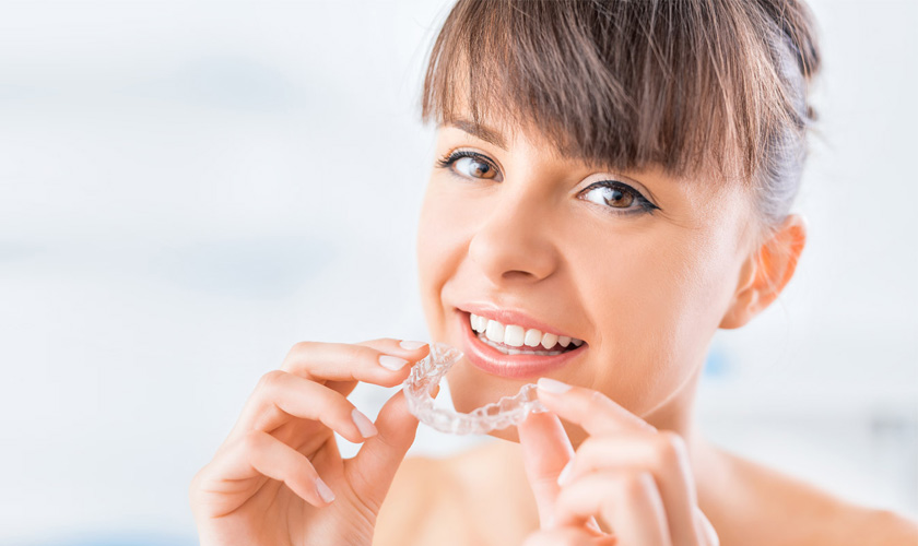 Wearing a piece of nightguard before bed to minimize tooth wear