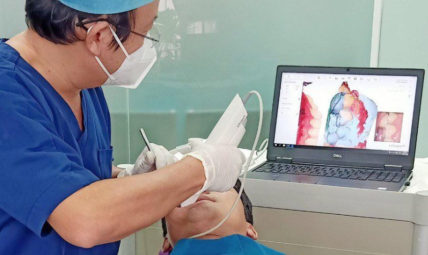 takes tooth impressions using 3Shape 3D digital technology